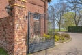 Access to an old farm. The facade and the walls of the enclosure are made of brick. Royalty Free Stock Photo