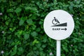 Accessibility in city public park, Sign board of Ramp for Disabled people or handicapped, Natural green leaf as backdrop wall