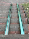 Green slabs of metal allow for wheelchairs or a stroller to pass Royalty Free Stock Photo