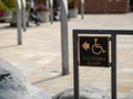 Accessible ramp sign pointing to the left in a public area Royalty Free Stock Photo