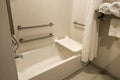 Accessible shower bath tub with handles and seat Royalty Free Stock Photo