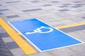 Accessible wheelchair sign with yellow tactile paving lines on marble pavement surface in public area Royalty Free Stock Photo