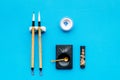 Accessories for chinese or japanese calligraphy. Special writting pen, ink on blue background top view copy space