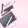 Accessories for drawing, set of colored alcohol based sketch drawing markers, refill, sketchbook and pen, on pink background, top Royalty Free Stock Photo