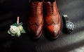 Accessories of the groom on wedding day. Mens shoes, boutonniere and watch composition