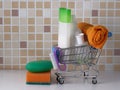 Accessories for laundry and cleanliness - soap, shampoo, towel in the shopping basket Royalty Free Stock Photo