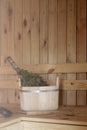 Accessories for the sauna in the wooden sauna. Wooden tub, birch broom in hot steam. Finnish bath Royalty Free Stock Photo