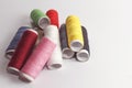 Accessories for sewing lie on a white background. Multicolored coils of threads. Royalty Free Stock Photo