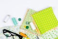 Accessories for sewing and needlework. Fabric, spools of thread, scissors and glasses Royalty Free Stock Photo