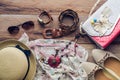 Accessories for teenage girl on her vacation, hat, stylish for summer sunglasses, leather bag, shoes and costume on wooden floor Royalty Free Stock Photo