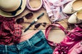 Accessories for teenage girl on her vacation, hat, stylish for summer sunglasses, leather bag, shoes and costume on wooden floor Royalty Free Stock Photo