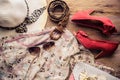 Accessories for teenage girl on her vacation, hat, stylish for summer sunglasses, leather bag, shoes and costume on wooden floor Royalty Free Stock Photo