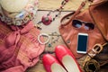 Accessories for teenage girl on her vacation. Straw hat, stylish sunglasses, brown leather bag, red shoes and costume on wooden fl Royalty Free Stock Photo