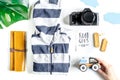 Accessories for treveling with children, camera and suit on white background top view