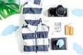 Accessories for treveling with children, camera and suit on white background top view