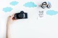 Accessories for treveling with children, camera and toys on white background top view mock-up