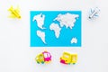 Accessories for treveling with children, map and toys on white background top view