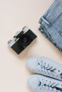 Accessories for urban travel. Jeans, sneakers, top view camera Royalty Free Stock Photo