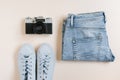 Accessories for urban travel. Jeans, sneakers, top view camera Royalty Free Stock Photo