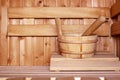 Accessories, a wooden bucket and a ladle, in a traditional Russian bath or Finnish sauna, in a cozy interior with natural Royalty Free Stock Photo