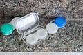 Accessories for working with contact lenses. Tweezers with contact lens and plastic container Royalty Free Stock Photo