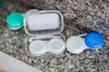 Accessories for working with contact lenses. Tweezers with contact lens and plastic container Royalty Free Stock Photo