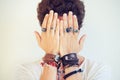 Accessorize to define yourself. Studio shot of a stylish young man wearing lots of hand accessories and holding them up