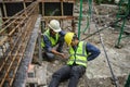 Accident of builder worker in work at construction site. Accident falls from the scaffolding on floor, Foreman support to help the Royalty Free Stock Photo