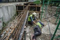 Accident of builder worker in work at construction site. Accident falls from the scaffolding on floor, Foreman support to help the Royalty Free Stock Photo