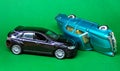 Accident of cars, toys on a plain green background.