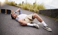 Accident, fall and knee injury with a skater man on the ground, lying down in pain after falling down. Sports, training