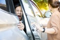 Accident,hand slammed the door,mischievous child girl was pinched her hand or fingers in the car door,asian daughter shouted in Royalty Free Stock Photo