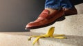 Accident in Daily Life Concept. Man Stepping Down Stair on a Banana Peel. Insurance Concept Royalty Free Stock Photo