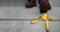 Accident in Daily Life Concept. Man Stepping Down Stair on a Banana Peel. Insurance Conceptual Royalty Free Stock Photo
