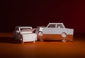 Accident between paper models of cars. White on red background