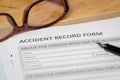 Accident report application form and pen on brown envelope and e Royalty Free Stock Photo