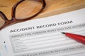 Accident report application form and pen on brown envelope and e Royalty Free Stock Photo