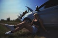 an accident on the road, a car broke down, two beautiful model girls are repairing the motor. Car problem. Friends are Royalty Free Stock Photo