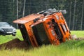 Accident on the road. A truck loaded with sand overturned into the roadside.