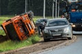 Accident on the road. A truck loaded with sand overturned into the roadside.