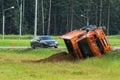 Accident on the road. A truck loaded with sand overturned into the roadside.