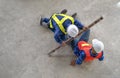accident in site work,a piece of iron fell from height hit on a worker's legs on floor while working at a new building