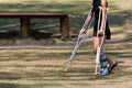 Accident tourist girl are walking by crutches in the garden. Royalty Free Stock Photo