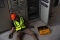 Accident in work of electrician people or Maintenance worker in the control room of factory. Sit and lean back against the control Royalty Free Stock Photo