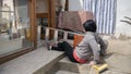 Accidents while cleaning domestic house where a caucasian girl falls off the ladder with broom and dustpan and bucket of water