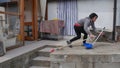 Accidents while cleaning domestic house where a caucasian girl falls off the ladder with broom and dustpan and bucket of water Royalty Free Stock Photo