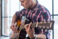 Accord chord, Close up of mens hands playing an acoustic guitar