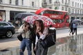 Rainy day in London city centre with people and umbrellas, England 2021