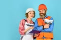 According to plan. Discussing renovation with contractor. Plastering works. Couple look documents. Woman and man safety Royalty Free Stock Photo