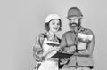 According to plan. Discussing renovation with contractor. Plastering works. Couple look documents. Woman and man safety Royalty Free Stock Photo